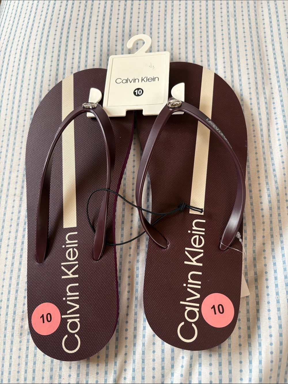 Calvin Klein Women's Dark Brown Flip Sandals with Cream Stripes, size 10.